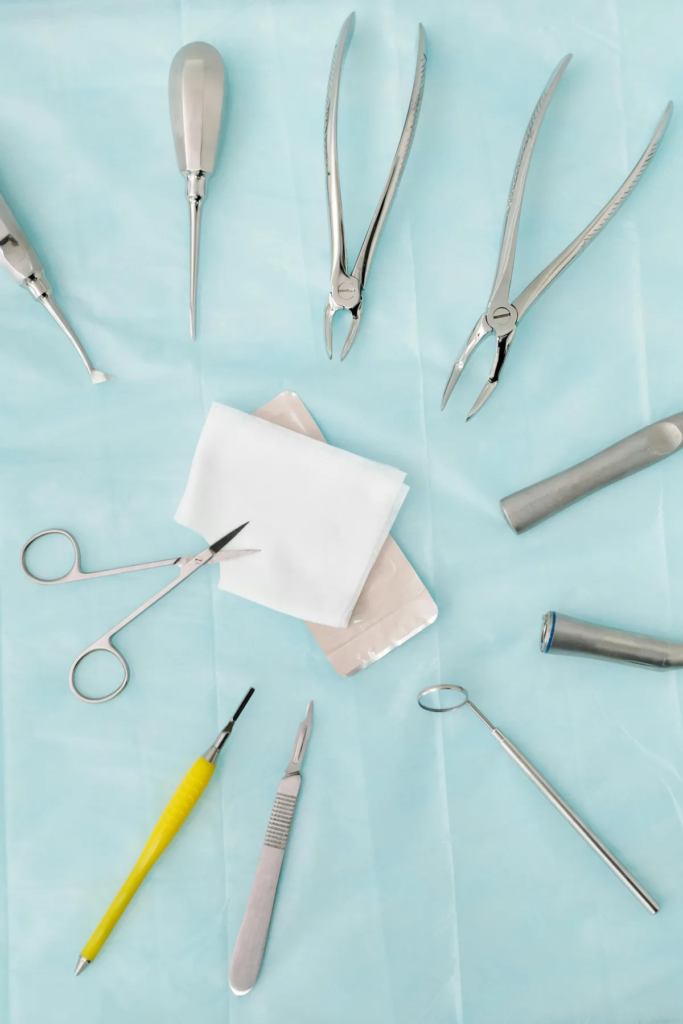image taken from above of various dental instruments on a blue cloth